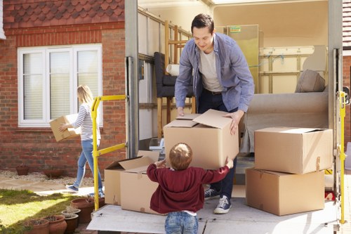 Professional movers handling office equipment